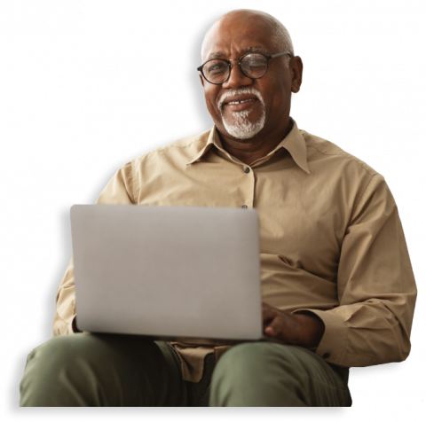 smiling older man at a laptop