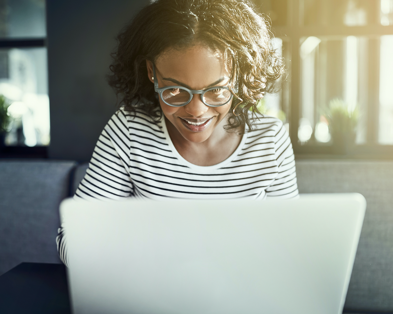 woman looking at a computer, smiling