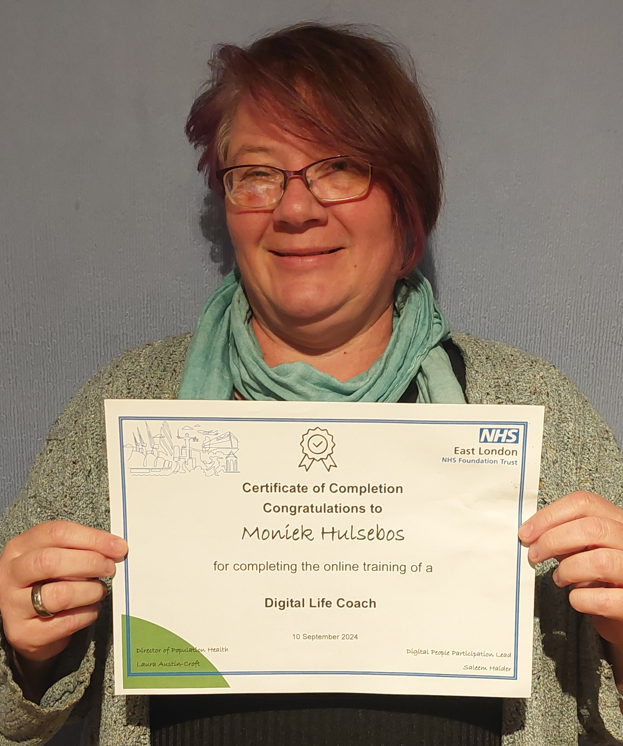 photo of a digital life coach holding up a certificate