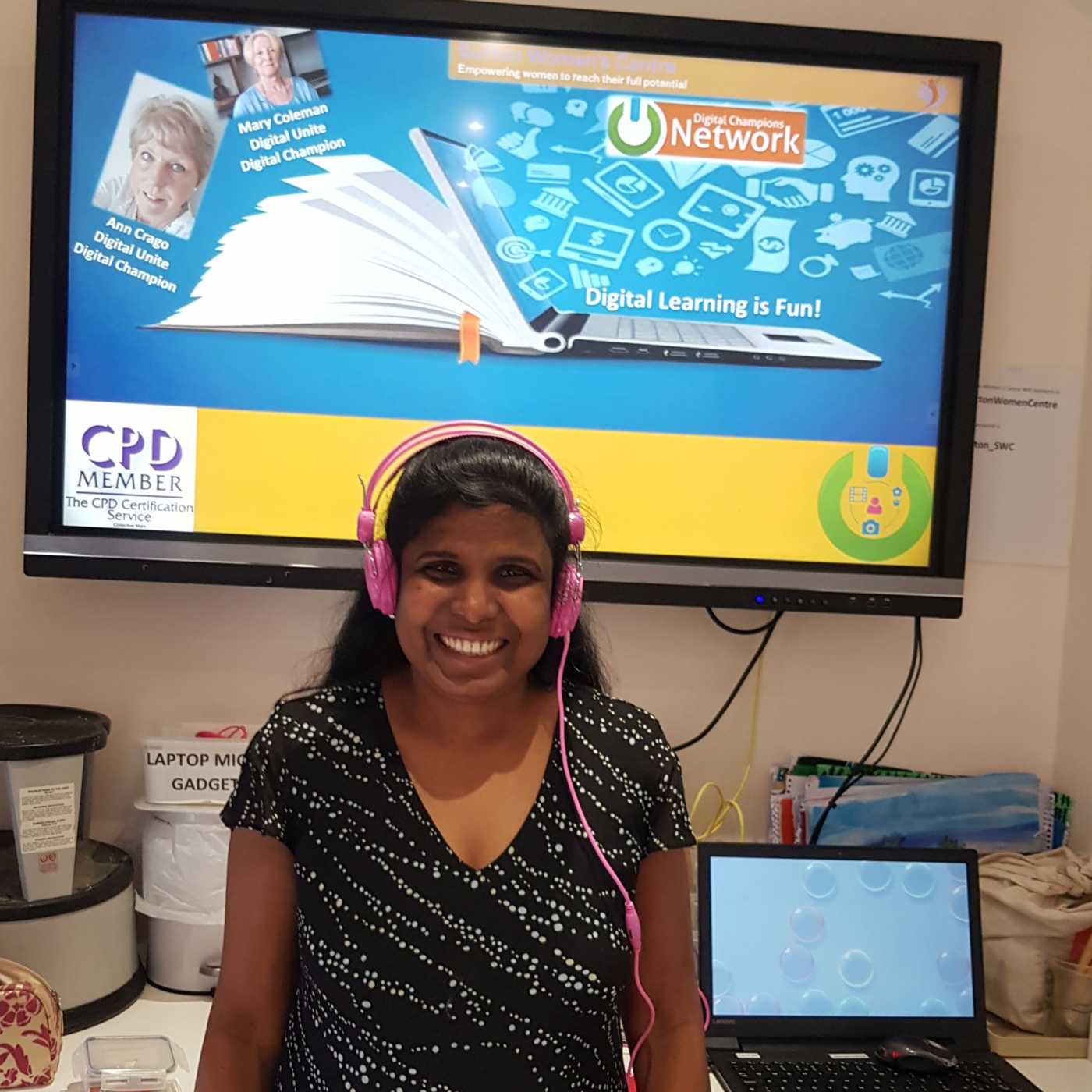 woman in front of a computer smiling