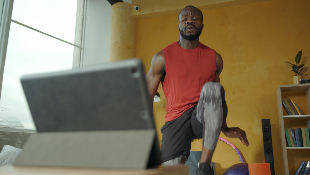 Man working out infront of laptop