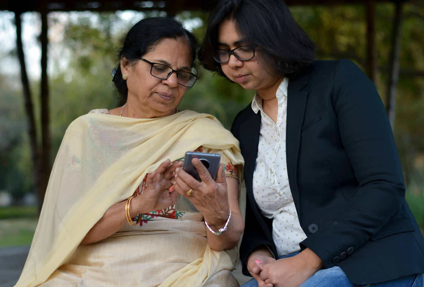 mum and daughter looking at a phone