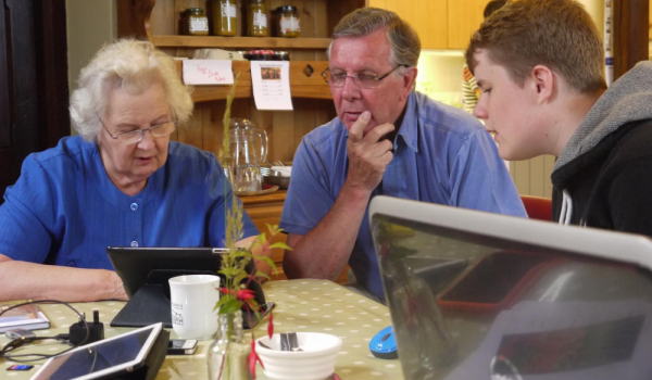 3 people look at a computer