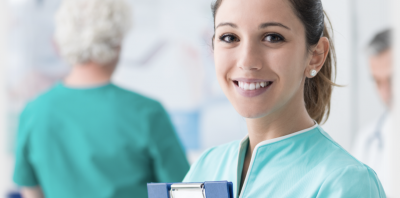 A female nurse smiling at the camera