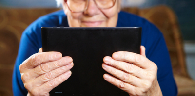 older woman looks at laptop