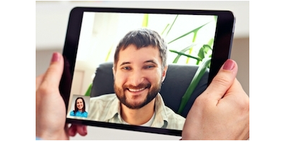 A screenshot of a tablet computer making a video call to a man from a woman