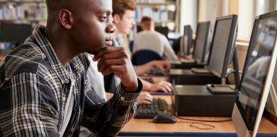 young man at library computer