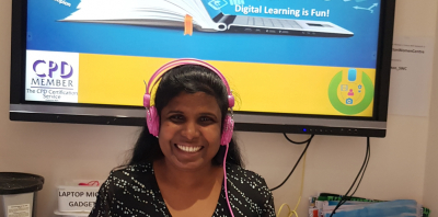 woman smiling in front of a computer