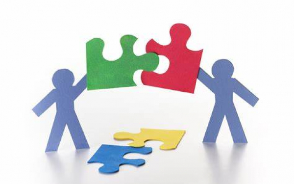 image depicting people holding jigsaw pieces together to reflect partnership working
