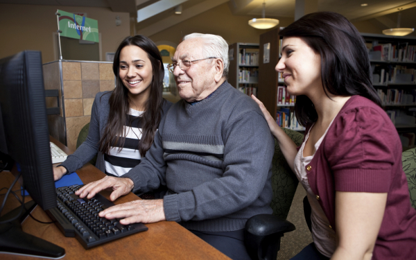 Two Digital Champions helping someone online