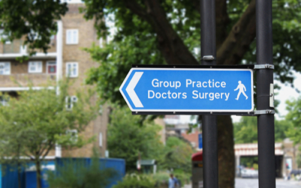 street sign saying "Group practice Doctors Surgery"