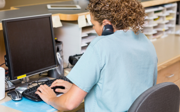 medical professional at a computer