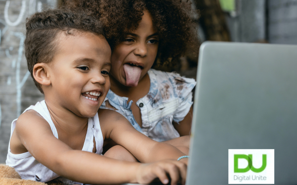 kids sticking their tongues out a computer