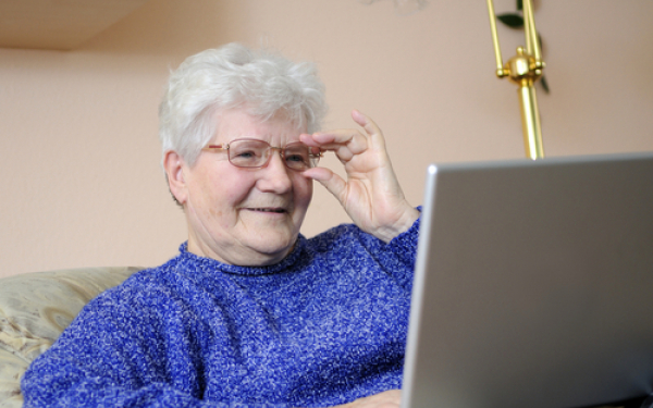 woman looking happy at a computer