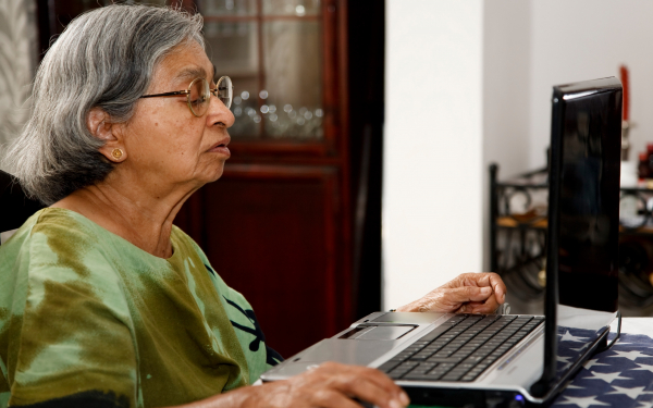 lady looking seriously at a laptop