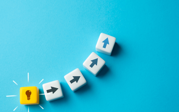 a graphic of a light bulb and arrows pointing upwards