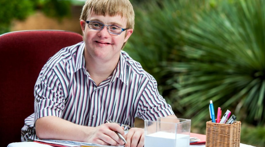 A person with learning disabilities, reflecting Digital Unite's new employability programme called Aspire
