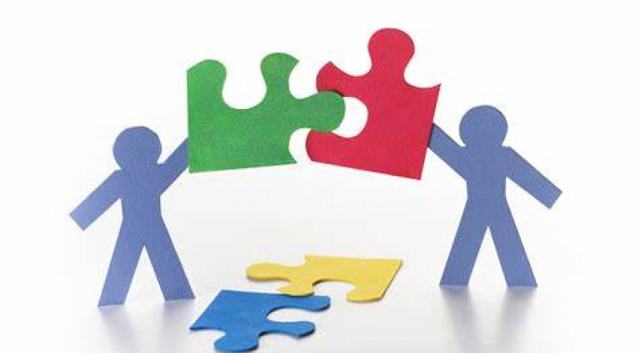 image depicting people holding jigsaw pieces together to reflect partnership working