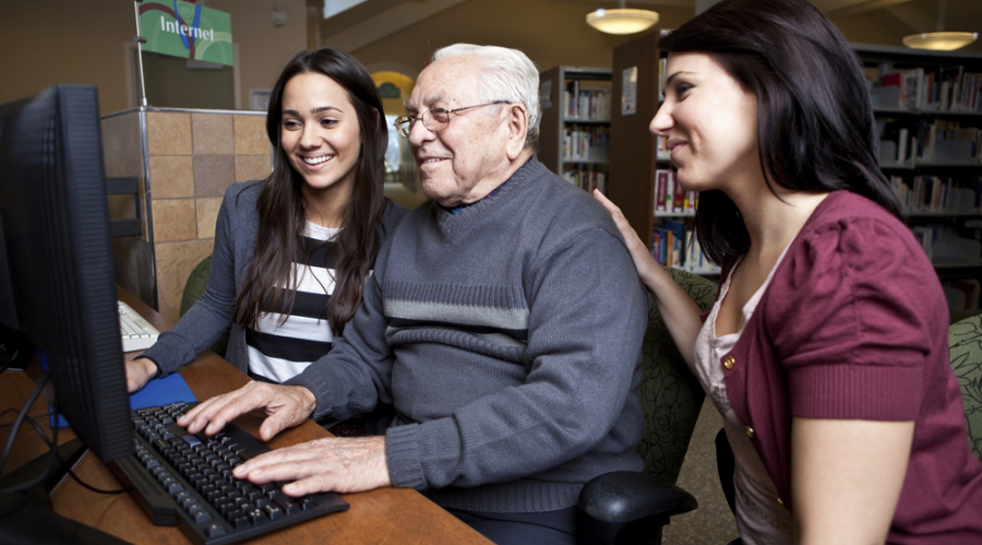 Two Digital Champions helping someone online