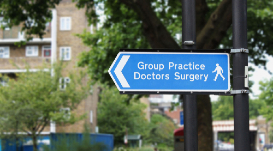 street sign saying "Group practice Doctors Surgery"