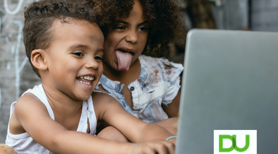 kids sticking their tongues out a computer