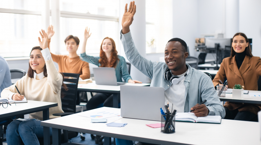 people at a workshop raise hands