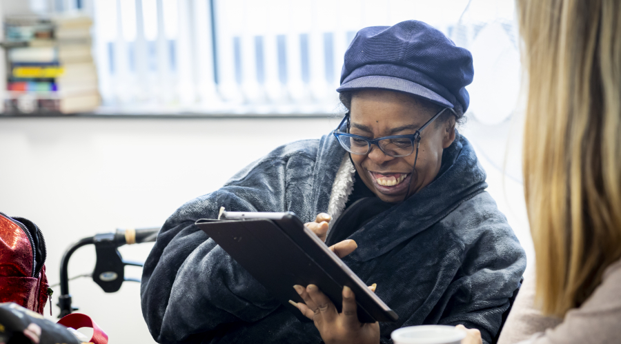 woman laughing at a screen